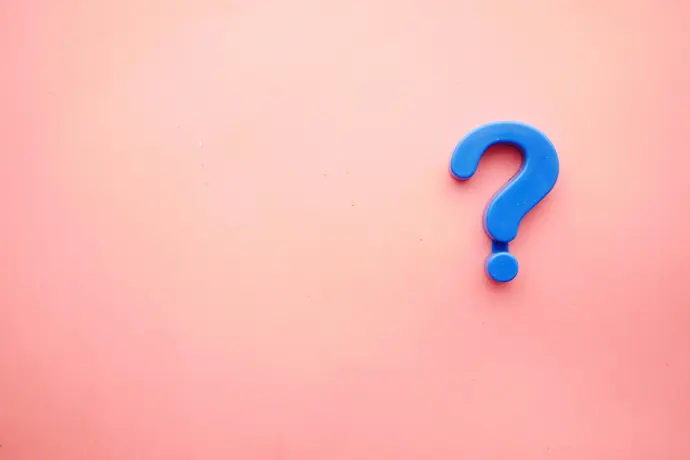 a blue question mark on a pink background